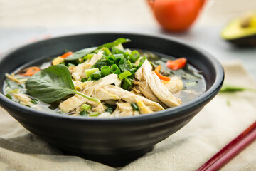 shredded chicken soup river with spring onion, and green leaves served in broth isolated on background side view of hong kong food