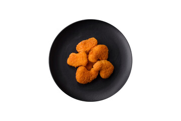 Delicious fresh crispy chicken nuggets on a dark concrete background