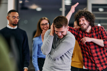 A group of young business people have fun playing interesting games while taking a break from work in a modern office. Selective focus 