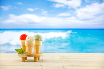 Ice cream in waffles on wooden table with summer beach background. Summer background for montage...