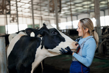 Happy young woman farmer hugging cow, concept love to animal, vet health care. Concept agriculture...