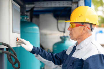 Hydraulic engineer doing safety check on new installation hoses of modern oil rig drilling industrial platform