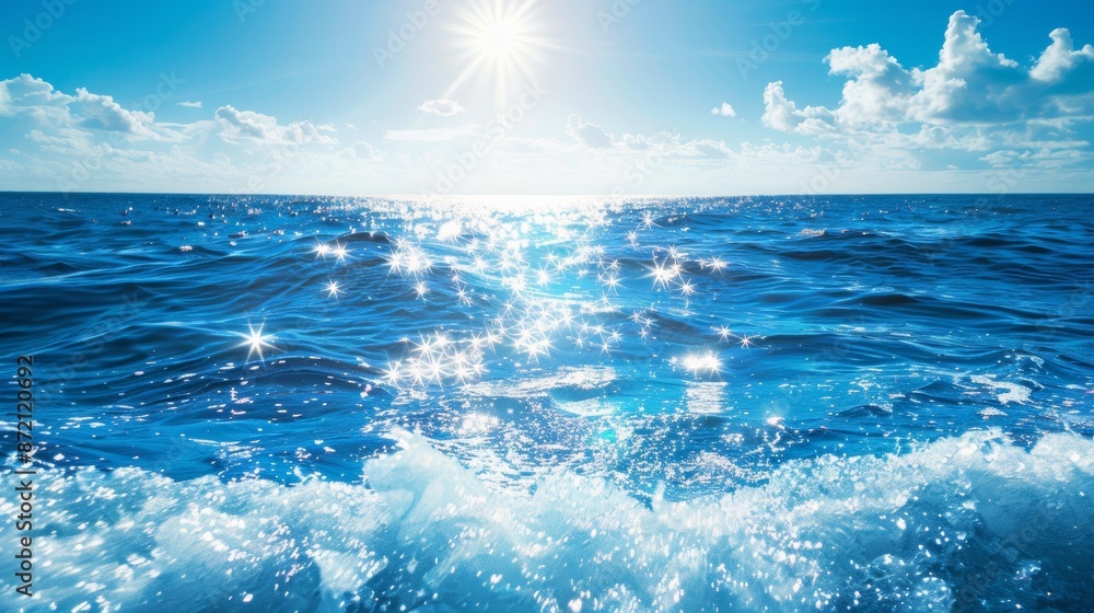 Wall mural sun rays creating sparkles on blue ocean waves with horizon
