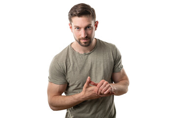 Handsome Male Model Against White Background, Hands Together, Posing to Camera with Neutral Face...