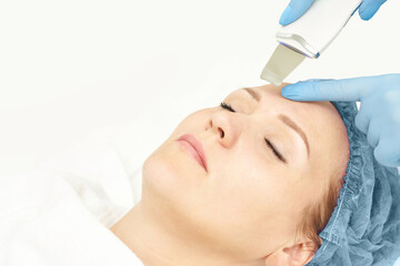 Ultrasound cosmetology scrubber. Face cavitation procedure. Salon skincare treatment. Professional peeling hardware. Electric spa equipment. Medicine patient device. Removal acne. Copyspace