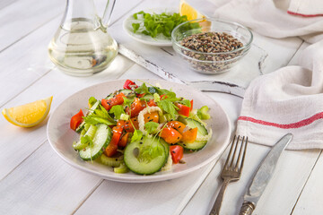 Salad of fresh cucumbers, celery, sweet peppers, herbs and pumpkin seeds, sunflowers, sesame seeds with olive oil. Healthy vegetarian, vegan food. Italian Cuisine