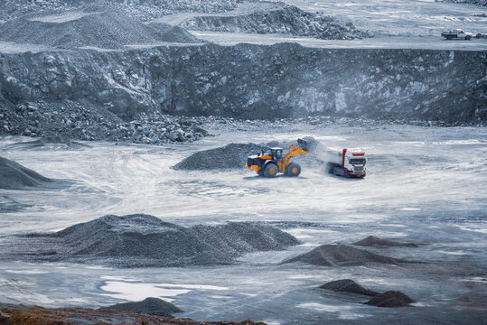 Loader filling a dump truck in an expansive diabase quarry. Parekklisia, Cyprus