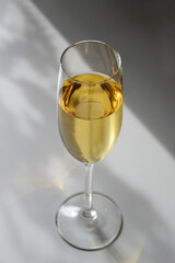 Glass full of white wine champagne on white background