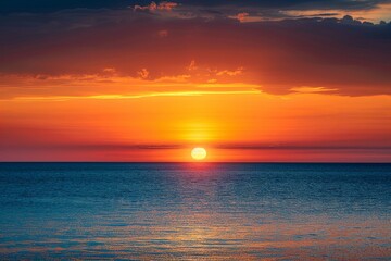 Obraz premium Ethereal Horizon: Sunset Over the Sea Painting the Sky in Shades of Orange