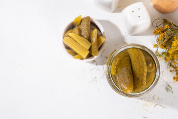 Homemade pickles in jar. Tasty gourmet pickled cucumbers with spices on kitchen table background copy space