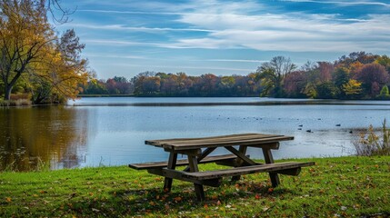 Obraz premium A picnic table by a serene lake.