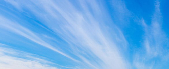 Blue sky with white clouds in the form of long stripes
