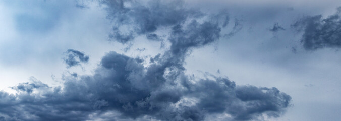 A blue rain cloud in a blue-gray sky