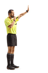 Football referee blowing a whistle and gesturing with hand
