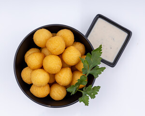 Deep fried Cheese balls. Delicious homemade appetizer. Freshly baked croquettes, served with basil leafs and sauce.
