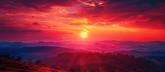 Fototapeta premium Breathtaking mountain sunset landscape. Majestic sunrise over colorful clouds and misty hills. Concept of nature, beauty, tranquility.