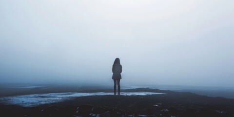 Lonely Figure Standing in Foggy Landscape Symbolizing Depression and Isolation