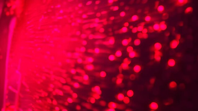 Red dots scattered on a black surface, creating a contrast in color, Experiment with the dual nature of binary code in a dynamic art piece