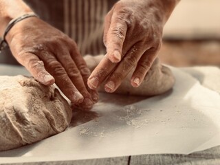Artisan baker kneading the dough.
