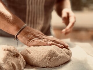 Artisan baker kneading the dough.
