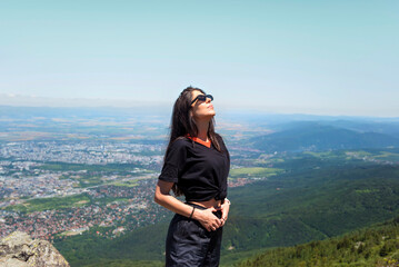 Naklejka premium Relaxed woman breathing fresh air in the spring mountain 