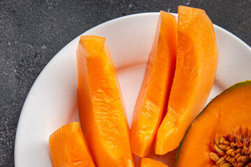 Melon Charentais sweet fruit fresh appetizer meal food snack on the table copy space food background rustic top view keto or paleo diet vegetarian vegan food