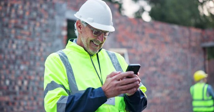 Mature man, engineer and laugh at phone on construction site for message, funny meme and positive feedback. Male contractor, happy and mobile on worksite for good news, information and comedy story