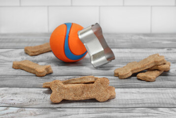 Homemade dog biscuits and a ball with selective focus