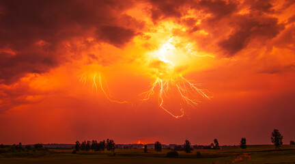 A stunning red sky lightning storm. Climate change concept