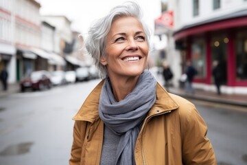 Fototapeta premium Portrait of a happy senior woman in a city street, smiling