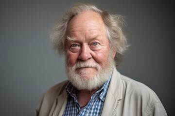 Portrait of a senior man with grey hair and beard, studio shot