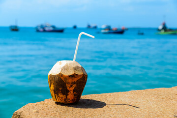 Coconut juice with blue water a background