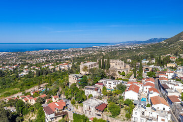 Fototapeta premium Bellapais Abbey overlooking Kyrenia city with mediterranean sea. Cyprus
