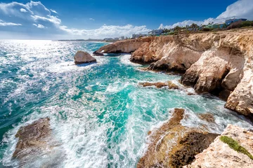 Turquoise sea water crashing on rocky coastline in Ayia Napa, Cyprus