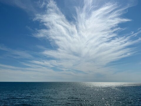 Amazing sky clouds above glittering sea