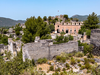 Ruins of abandoned village Kayakoy in Turkey ghost town, ruined church and castle