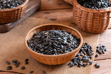 Raw sunflower seeds on wooden table, closeup view