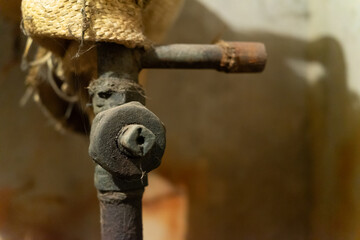 Antique rusty shut-off valve in basement