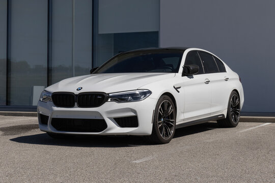 Used BMW M5 display at a dealership. With pricing concerns, BMW is selling preowned cars to meet demand. MY:2018