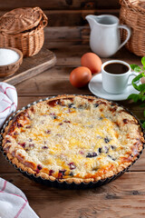 Delicious blueberry pie with raspberries on a wooden table. Homemade baking