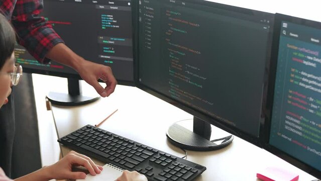 Slow motion back end or software developer manager supervising his team on new application program development on debugging and solving complex code algorithms on monitor. Burgeoning