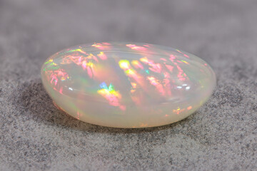 Very-high quality focus bracketing of a Colorful milky opal gem from Welo Ethiopia on grey...