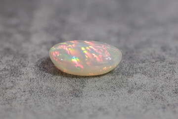 Very-high quality focus bracketing of a Colorful milky opal gem from Welo Ethiopia on grey background