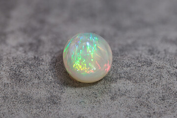 Very-high quality focus bracketing of a Colorful milky opal gem from Welo Ethiopia on grey background