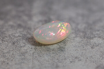 Very-high quality focus bracketing of a Colorful milky opal gem from Welo Ethiopia on grey...