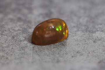 Very-high quality focus bracketing of a Colorful opal gem on grey background