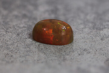 Very-high quality focus bracketing of a Colorful opal gem on grey background
