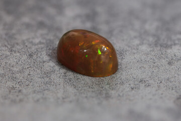 Very-high quality focus bracketing of a Colorful opal gem on grey background