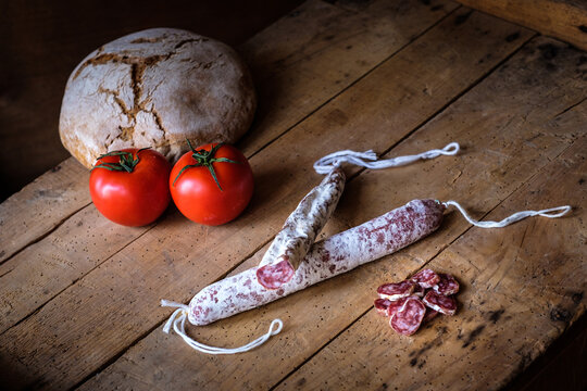 Traditional Spanish fuet and assorted cured meats with tomatoes