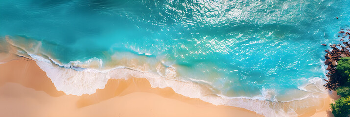 Aerial photo of a summer beach with turquoise ocean and clear sky. Perfect for travel, vacation, and holiday designs. Includes copy space.